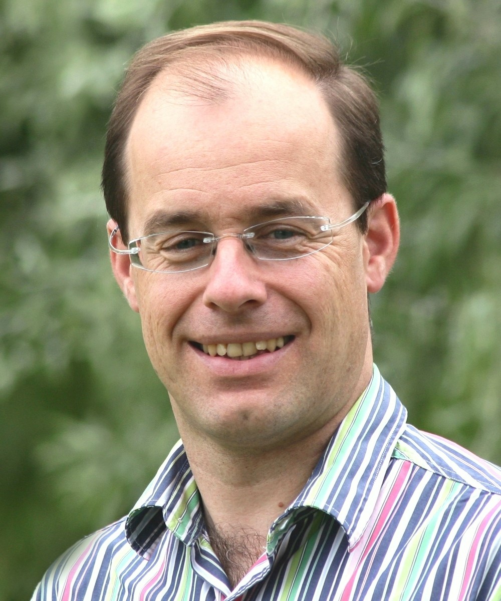 A person wearing glasses  Description automatically generated with low confidence